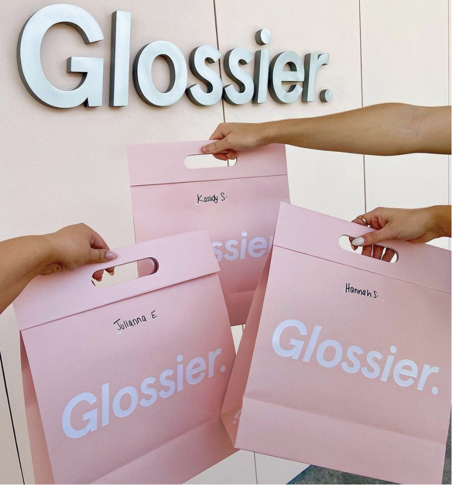 Glossier's packaging using their branded pink color